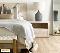 a bedroom with white walls and wood floors