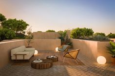 an outdoor living area with furniture and plants