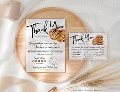 two thank you cards on top of a wooden plate next to some oatmeal