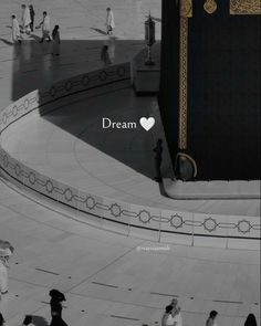 an image of people walking around in front of a large building with the words dream written on it