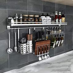 a kitchen wall shelf with various cooking utensils and other items hanging on it