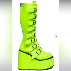 Tongue Twizt Trinity Boots Demonia Enter The Matrix In These Exxxclusive Knee High Platform Boots That Have A Neon Neoprene Construction, Tonz Of Adjustable Buckles With Metal Plates, And Back Zip Closures. They Glow In The Dark! Man Made Materials 5.5" Heel 3.5" Platform Highlighter Color Green Platform Party Boots, Yellow Lace-up Platform Boots, High-top Yellow Boots For Spring, Yellow Platform Lace-up Boots, Yellow Closed Toe Boots For Spring, Yellow Leather Platform Boots With Round Toe, Trinity Boots, Rave Boots, Demonia Platforms