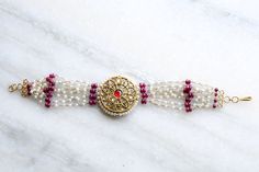 22kt Solid Gold Polki diamond Ruby Bracelet fresh water Pearl bracelet Genuine bracelet Victorian Bracelet Anniversary Gift Gift for her Polki diamond are natural mined diamond which are mined from earth crust and  the shimmer of the diamond is rustic. The bracelet is a combination of polki diamond , Rare Ruby Pearl which executed the design into a mughal style which is a ancient which is looks different and giving different style. Specification 1. Metal : 22Kt Solid Gold 2. Hall marked : 22kt 3. Weight : 16.25 Gram 4. Size : 7.5 Inches 5. Gemstone : Polki diamond, Rare Rubies and Fresh water Pearl  Happy Shoping Pearl And Ruby Bracelet, Ruby Bracelets With Intricate Design As Gift, Elegant Ruby Bracelets With Intricate Design, Ruby Bracelet With Diamond Accents, Luxury Gold Ruby Bracelets, Victorian Bracelet, Ruby Bracelet, Adjustable Jewelry, Freshwater Pearl Bracelet