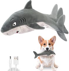 a dog is holding a stuffed shark in front of it's face and head