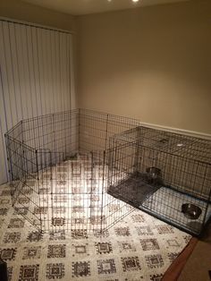 two cages are sitting on the floor in an empty room