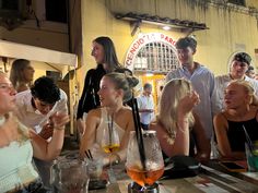 a group of people sitting at a table with drinks