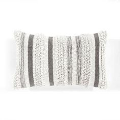 a black and white striped pillow on a white background