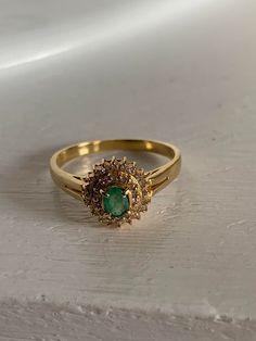 k18 gold ring 2.2 grams emerald gem stone 0.21 carat diamond around the gem stone is 0.17 carat size 10.5 This is a preloved ring. Been using it for a few years now. Indian Gold Stone Rings, Year Rings Gold, Design Of Rings Gold, Indian Traditional Stone Rings, Indian Rings Gold, Emerald Rings Gold, Green Stone Gold Ring, Green Stone Ring For Women, Gold Ring With Stone