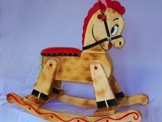 a wooden rocking horse with red and black stripes on it's body, sitting against a blue background