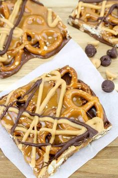 chocolate caramel pretzel barkle bars on parchment paper with cookies and candy in the background