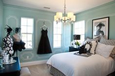 a bedroom decorated in black and white with mannequins on the wall next to it