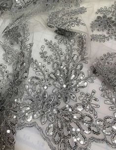 Silver Sequin Floral Embroidered Tulle Fabric Elegant Floral Embroidered Net Fabric, Elegant Floral Embroidered Fabric For Party, Elegant Silver Floral Embroidered Fabric, Elegant Embroidered Net Tulle Fabric, Glamorous Embroidered Sequin Fabric For Festive, Elegant Silver Embroidered Organza Fabric, Elegant Embroidered Sequin Fabric For Spring, Silver Festive Fabric With Resham Embroidery, Festive Silver Fabric With Resham Embroidery