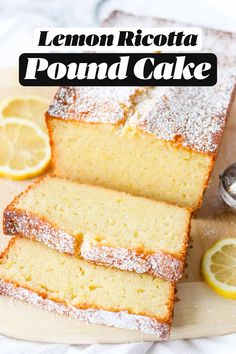 lemon ricotta pound cake on a cutting board with sliced lemons and powdered sugar