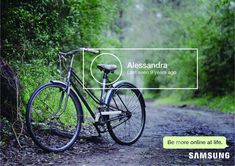 a bike parked on the side of a dirt road next to green bushes and trees