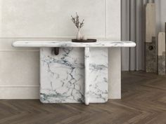 a white marble console table with a vase on it's top and some plants in the corner