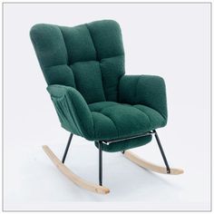 a green rocking chair sitting on top of a white floor next to a wooden frame