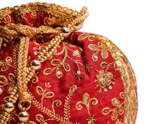 Red Potli Bag with Pearl Handle Strap Products that are out of stock are restocked in 3 weeks’ time. Call us at +1 925 791 0374 to place your order. An ideal for brides rocking the classic red bridal lehenga on their wedding, with its classy zari work and a pearl handle strap all in gold the Dulhan Potli Bag is ready to beautify you. Fabric: Raw Silk Color: Red Embroidery: Zari Work in Gold Size & Dimensions: Height - 8 inWidth - 7.5 inDepth - 1.5 in Strap: Pearl Handle Strap Closure: Tassel Red Bridal Lehenga, Bridal Mask, Potli Bag, Ethnic Bag, Bridal Lehenga Red, San Ramon, Potli Bags, Wedding Purse, Red Embroidery