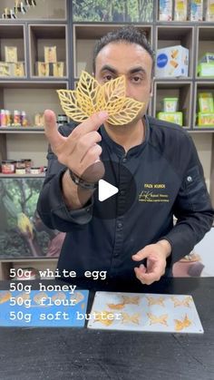 a man holding up a piece of paper with the words 50g white egg on it