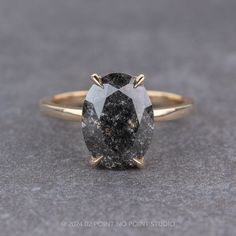 black diamond Black Sapphire Engagement Ring, Black Oval Diamond Cut Rings, Black Oval Rings With Diamond Accents, Grey Black Diamond Engagement Ring, Engagement Ring Basket, Black Speckled Diamond Engagement Ring, Black Speckled Diamond Ring, Black Engagement Rings, Black Stone Engagement Ring