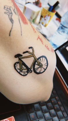 a tattoo on the arm of a person with a bike