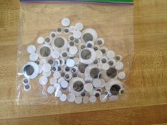 there are many buttons in the bag on the table and one is white with black dots