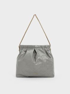 To match the moodier ambience of the coming days, the Duo is now available in a slate grey finish. The iconic slouchy folds and quilted texture is given a sophisticated, understated appearance in this new neutral, which will blend in seamlessly with your wardrobe. Complemented by gold-tone chains, this versatile silhouette makes the perfect everyday bag that will always look elegant. Charles Keith, Double Chain, Slate Grey, Everyday Bag, Hobo Bag, Gold Tones, Wish List, Texture, Chain