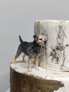 a small dog figurine on top of a cake