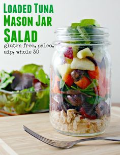 a salad in a mason jar on a cutting board