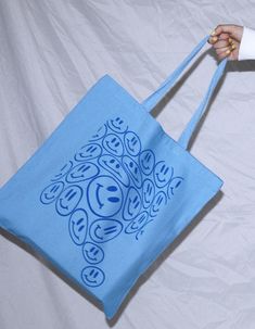 This adorable tote bag features the cutest smiley pattern. It's the perfect go-to reusable tote! PRODUCT DETAILS: -dimensions - 14" x 16" -100% heavy cotton canvas -all designs are created by orijenal Questions?? Please don't hesitate to contact us! Large Blue Canvas Bag, Blue Trendy Canvas Bag For Everyday Use, Blue Bags With Graphic Print For Daily Use, Trendy Blue Canvas Bag For Everyday Use, Blue Rectangular Bag With Graphic Print, Cute Blue Cotton Bags, Fun Cotton Tote Canvas Bag, Blue Large Capacity Cotton Canvas Bag, Fun Cotton Bags For Everyday Use