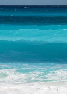 a man riding a surfboard on top of a wave in the ocean