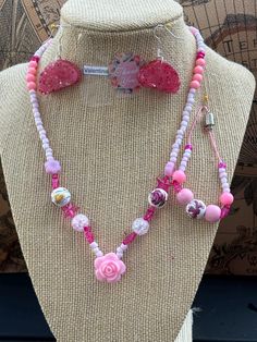 This beautiful pink beaded necklace set is perfect for adding a touch of girly glam to any outfit. The set includes a long necklace with a variety of pink beads, including pink glass beads, pink acrylic beads, and pink seed beads. A sparkling pink star charm and a delicate rose charm add a touch of whimsy to the design. The necklace is finished with a lobster clasp closure. The set also includes a shorter necklace with pink beads and a magnetic clasp closure. Adjustable Single Strand Pink Beaded Necklace, Pink Heart Beads Jewelry For Party, Pink Beaded Chain Jewelry For Gift, Pink Single Strand Beaded Necklace For Gift, Adjustable Pink Beaded Jewelry, Cute Pink Beaded Chain Jewelry, Handmade Adjustable Pink Necklace, Adjustable Pink Beaded Chain Necklace, Pink Party Necklace With Heart Beads