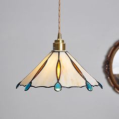 a lamp hanging from a ceiling next to a mirror