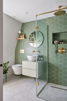 a bathroom with green hexagonal tiles on the wall