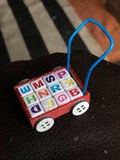 a small toy car with letters on it