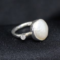 Reveal Timeless Elegance! Looking for a stunning accessory that blends tradition with contemporary appeal? Our collection is just for you! Our Natural Pearl Ring is here to grace you. Enjoy the charm of our Natural Pearl Ring, a masterpiece meticulously handcrafted to perfection. Made of 925K Sterling Silver, this ring reflects the richness of Roman art while adding a modern touch. This stunning piece features a brilliant white pearl, a symbol of purity and sophistication. The 14K White Gold Eur Handmade White Gold Pearl Ring, Handmade Unique White Gold Pearl Ring, Unique Handmade White Gold Pearl Ring, White Hand Forged Minimalist Jewelry, White Minimalist Hand Forged Jewelry, Contemporary Diamond Jewelry For Wedding, Contemporary Silver Jewelry For Wedding, Unique Diamond White Round Jewelry, Elegant One Of A Kind Open Ring Jewelry