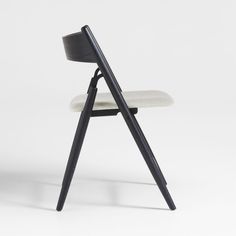 a black chair with a white seat and back rest on a white background in the shape of a triangle