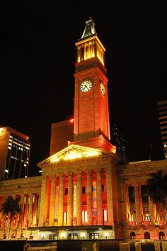 a large building with a clock tower lit up at night