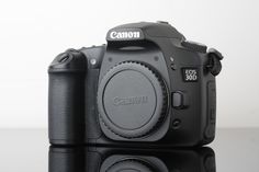 the canon eos - 1 camera is shown on a reflective surface