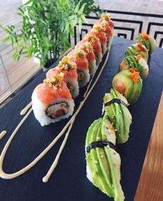 several sushi rolls are lined up on a table