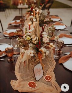 the table is set with candles and plates