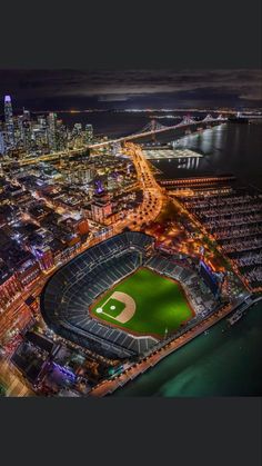 an aerial view of a baseball stadium and the city lights at night in chicago, illinois