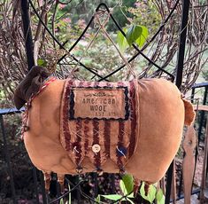 a stuffed horse is attached to a fence