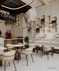 the interior of a coffee shop with tables and chairs