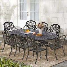 an outdoor table and chairs on a patio