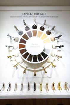 a display case with different colors of keys and handles on the wall above it is a circular graphic that says express yourself