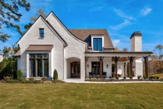 a white brick house with black shutters and windows