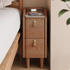 a wooden night stand with two drawers next to a bed and potted plant on the nightstand