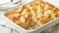 a casserole dish with bread cubes in it on a blue and white napkin