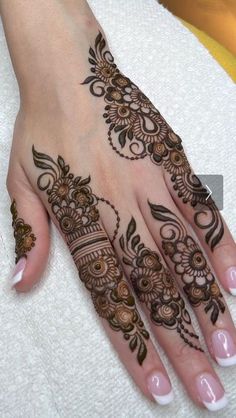 a henna tattoo is on someone's hand