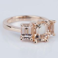 an engagement ring with three emerald cut stones